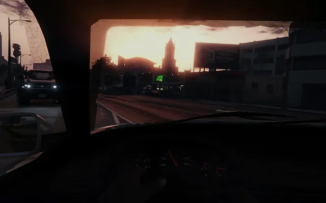 First-person view from the driver's seat at sunset, with a car coming the other way