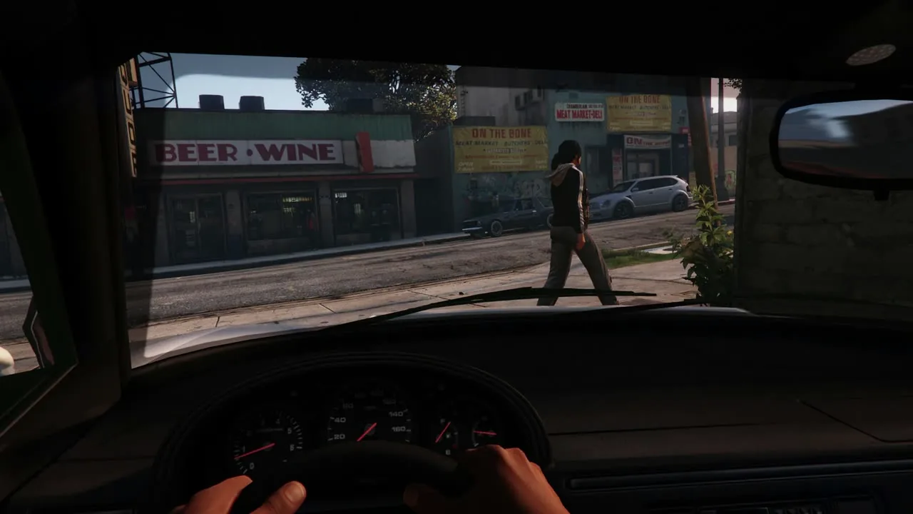 First-person view from the driver's seat of a car on a city street
